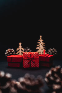 Close-up of christmas decoration on table against black background