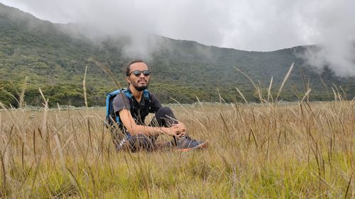 Portrait of young man standing on field