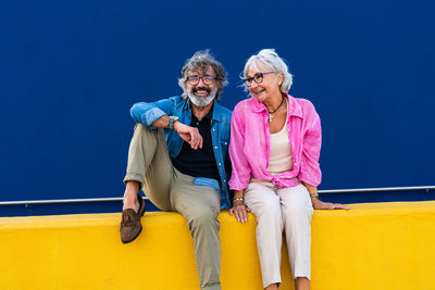 Portrait of female friends sitting on stage