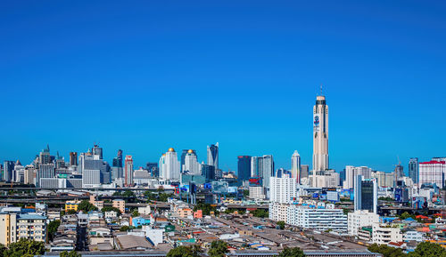 Modern buildings against clear blue sky