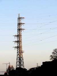 Low angle view of electricity pylon against sky