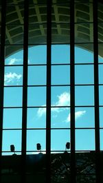 Low angle view of silhouette glass building against sky