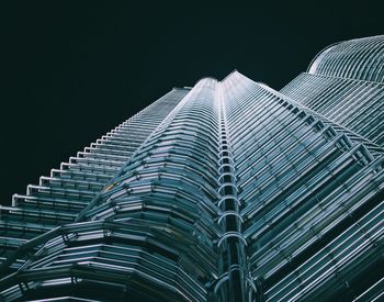 Low angle view of modern building against sky at night