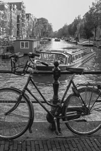 Bicycle on riverbank against sky