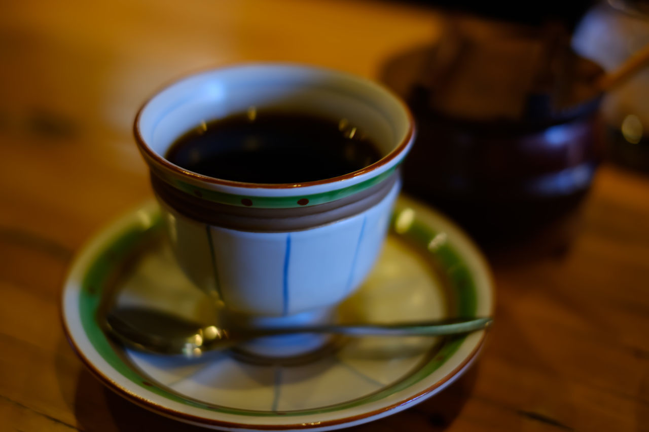 CLOSE-UP OF CUP OF COFFEE ON TABLE