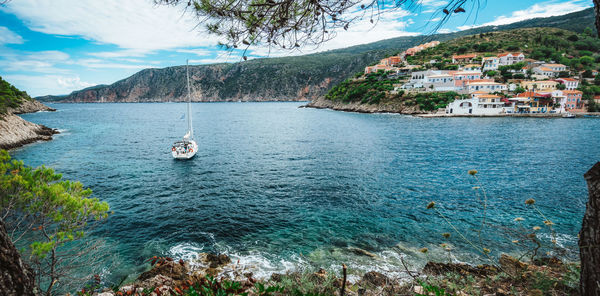 Scenic view of sea by buildings against sky