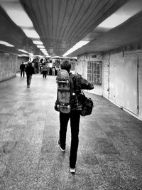 Full length of woman standing by railing