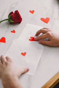 Cropped hands of woman drawing on paper