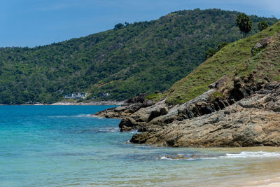 Scenic view of sea and mountains against sky