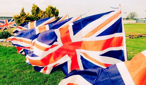 Low angle view of flag against blue sky