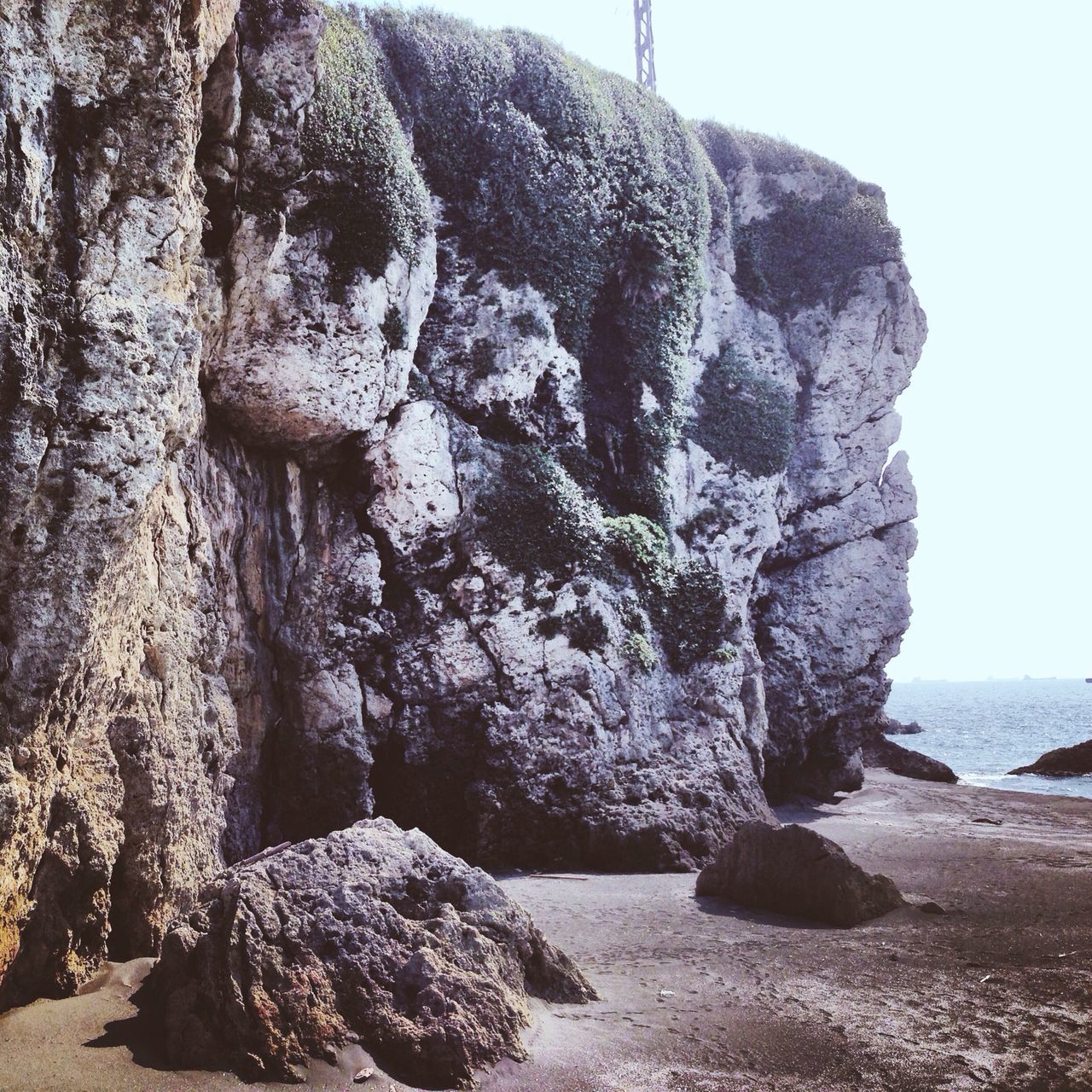 rock - object, sea, water, rock formation, rock, tranquility, tranquil scene, nature, scenics, beauty in nature, beach, stone - object, stone, sky, clear sky, shore, textured, horizon over water, day, outdoors