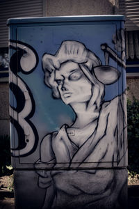 Close-up of angel statue against wall