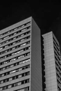 Low angle view of buildings against sky at night