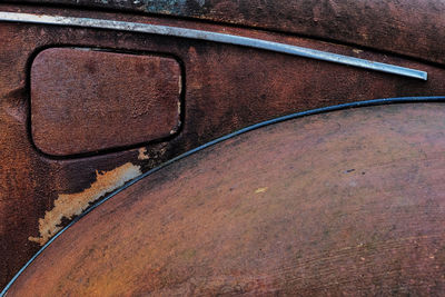 Close-up of old abandoned car gas tank lid