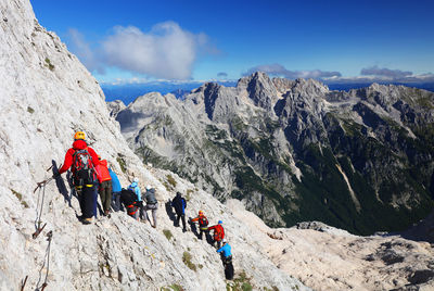 High angle view of hikers hiking on rocky mountain