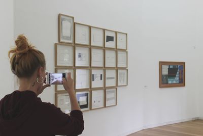 Portrait of woman photographing at home