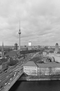 Modern buildings in city against cloudy sky