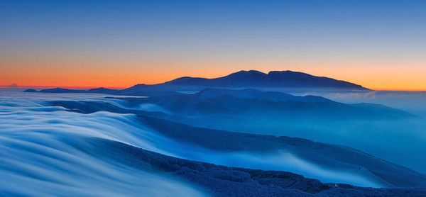 Scenic view of mountains against sky during sunset