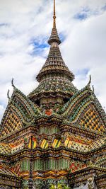 Low angle view of building against cloudy sky