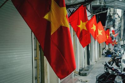 Close-up of red flags hanging on clothesline