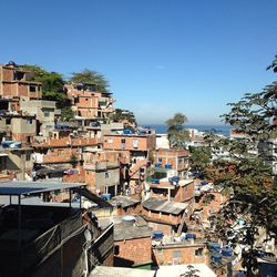 High angle view of houses in town against clear sky