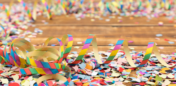 High angle view of multi colored streamers and confetti on table