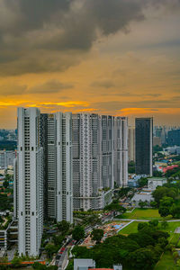 Buildings in city against sky during sunset