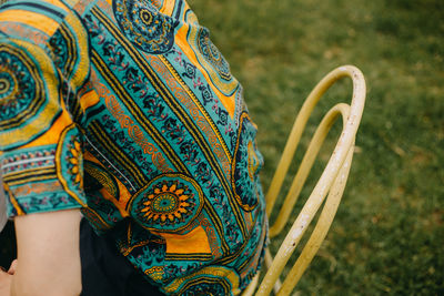 Midsection of person wearing patterned shirt