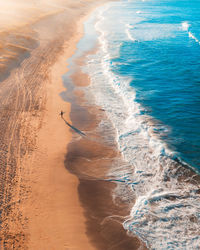 Aerial view of man standing on shore at beach