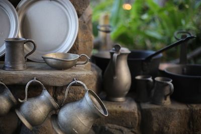 Old containers on table outdoors