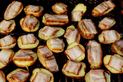 Full frame shot of meat and potatoes on barbecue grill