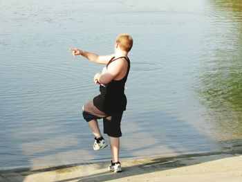 Young woman jumping in water