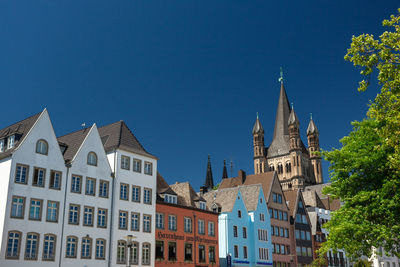 Low angle view of buildings against blue sky