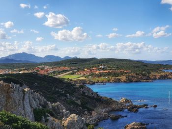 Scenic view of sea and mountains against sky