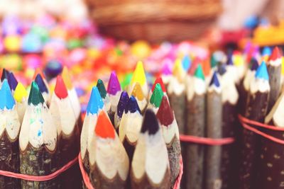 Close-up of colored pencils tied up with rubber bands