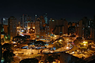 High angle view of illuminated cityscape against sky at night