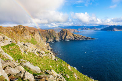 Panoramic view of sea and mountains against sky