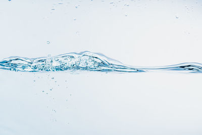 Close-up of water splashing against white background