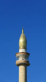 Low angle view of bell tower against blue sky