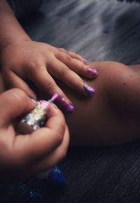 Close-up of woman hand holding purple