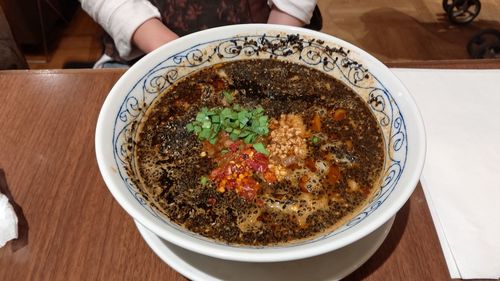 Midsection of woman by food in bowl