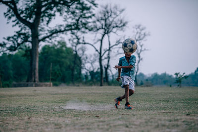 Full length of girl running on field