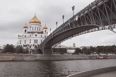 Bridge over river with city in background