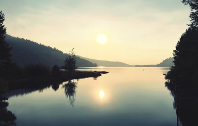 Scenic view of lake against sky during sunset