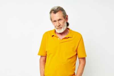 Portrait of young man standing against white background