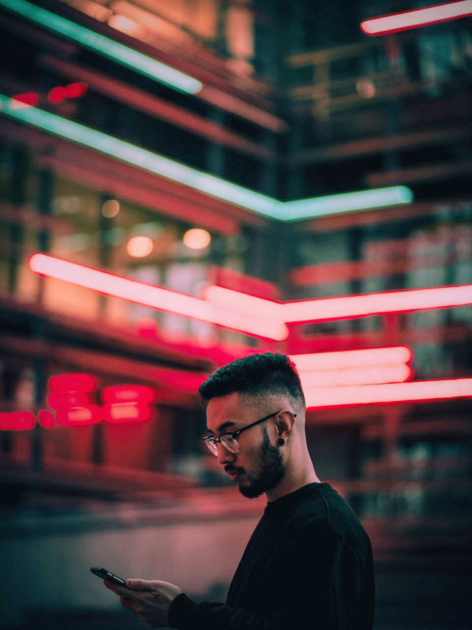 one person, real people, young adult, eyeglasses, illuminated, young men, focus on foreground, technology, lifestyles, wireless technology, night, indoors, people