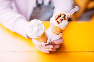 Close-up of hand holding ice cream