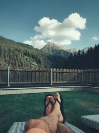 Low section of man relaxing on mountain