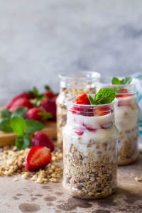 Homemade healthy breakfast with homemade baked granola, fresh strawberry and yogurt. 