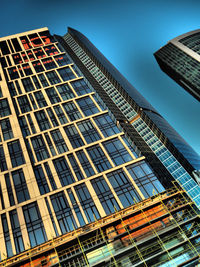 Low angle view of modern building against blue sky